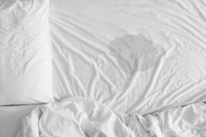 Bett- bzw. Einnässen im Erwachsenen- oder Babyalter, ausgewählter Fokus bei Nässe auf dem Bettlaken